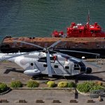 Am Hafen von Brest von oben gesehen ein Hubschrauber und ein Feuerwehrboot